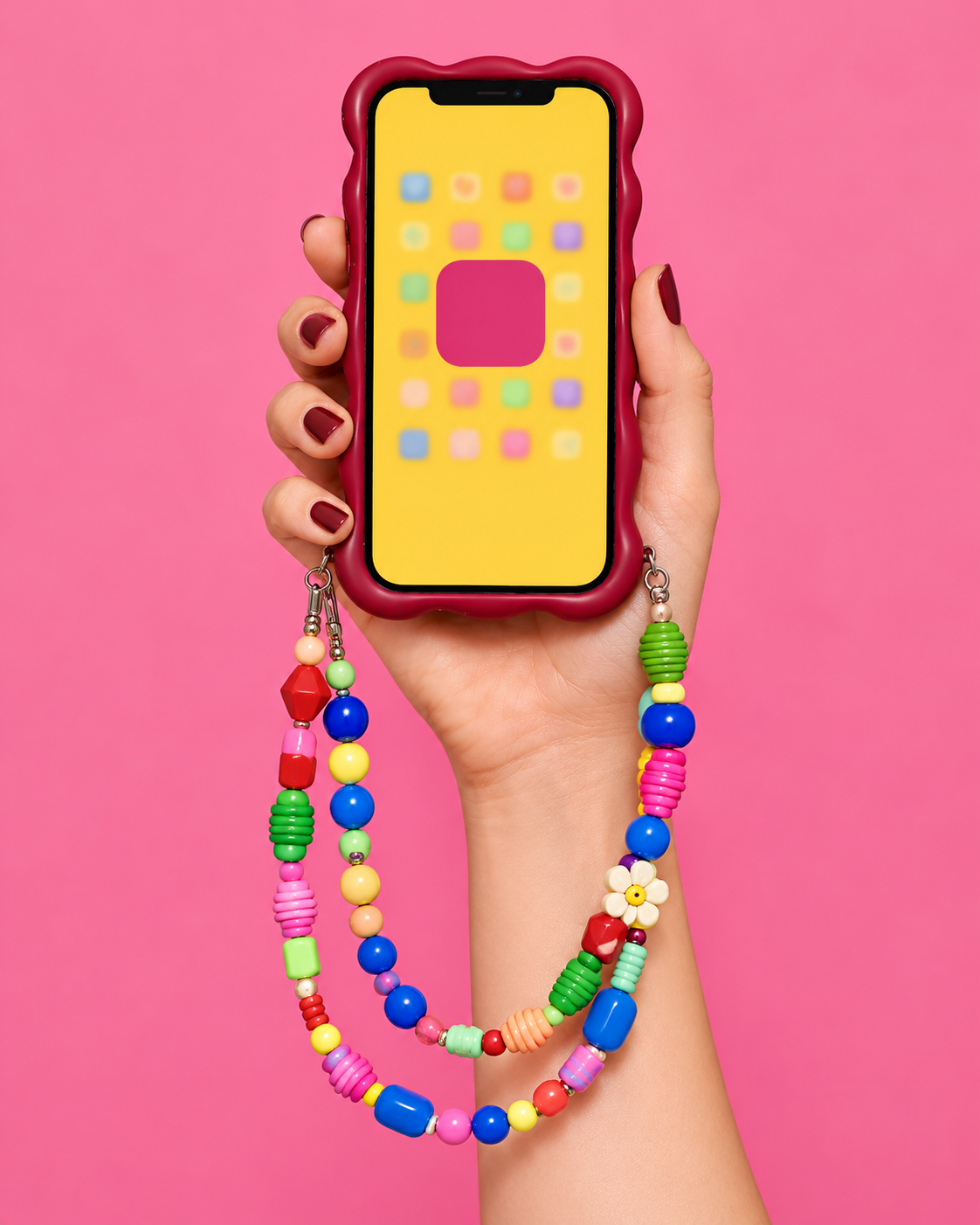 Piste 1 : téléphone jaune et perles colorées, sur fond rose.